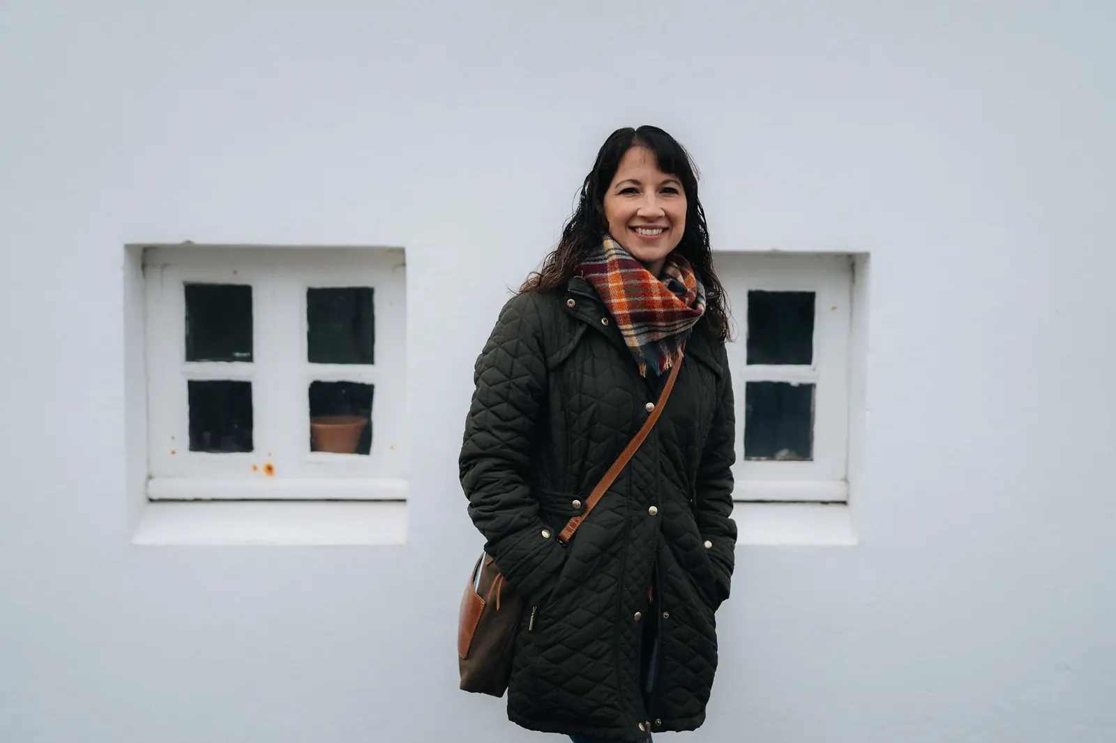 Lydia smiling in front of a white wall